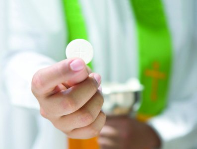 Priest Holding Communion Wafer